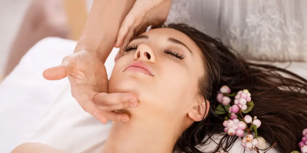 Woman receiving a relaxing professional skin care facial treatment with natural botanical accents at Healthcare Treat.