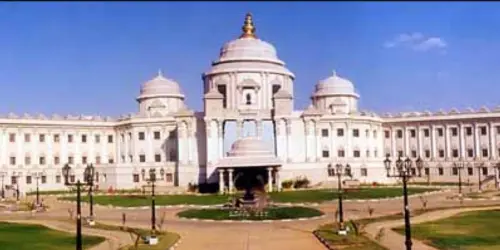 Sai Baba Hospital building exterior with a large central dome and landscaped entrance.